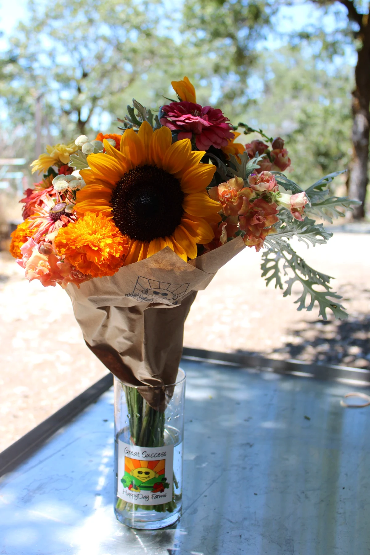 Fresh HappyDay Farms bouquet with sunflower, zinnias, marigolds and seasonal flowers